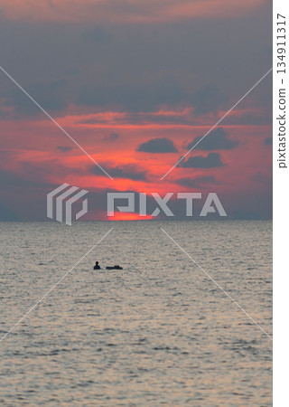 Sunrise and silhouette of a fisherman in the sea at Phuket city Sunrise and silhouette of a fisherman in the sea at Phuket city 134911317