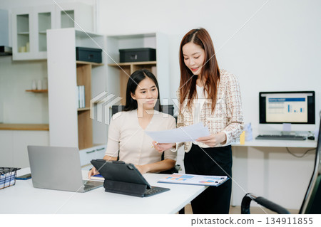 Business portrait two woman asian smile cheerful talk and holding tablet, computer and hands up happy with in agreement ready new project Business portrait two woman asian smile cheerful talk and holding tablet, computer and hands up happy with in agreement ready new project 134911855