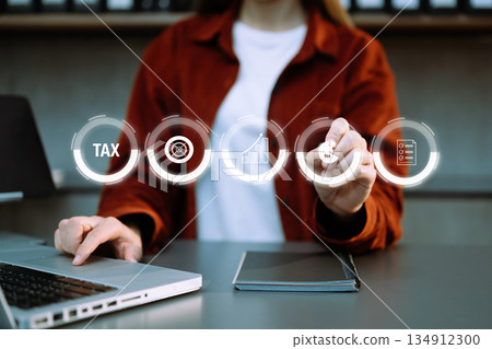 Busines using a computer to complete Individual income tax return form online for tax payment.Tax and Vat concept. Busines using a computer to complete Individual income tax return form online for tax payment.Tax and Vat concept. 134912300