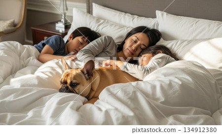 Parents, children and pet dog sleeping together in the morning light 134912380