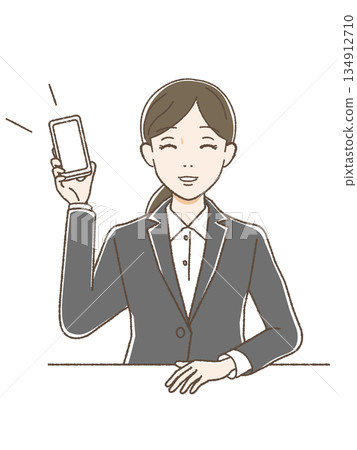 一位身穿西裝的女子麵帶微笑,展示著她的智慧型手機螢幕和上半身。 一位身穿西裝的女子麵帶微笑,展示著她的智慧型手機螢幕和上半身。 134912710