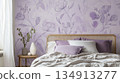 A bedroom with a purple wall and a bed with pillows and a vase on a table 134913277