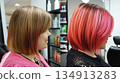 Two different hairstyles, one with pink highlights and the other with pink 134913283