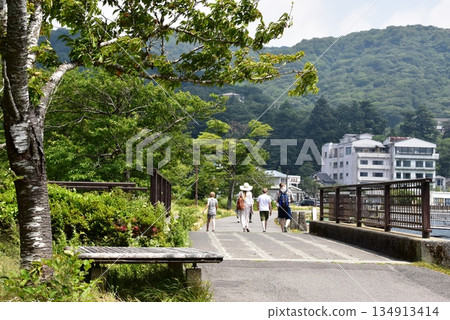 Hakone Town: A foreign family strolling near Motohakone Port on Lake Ashi Hakone Town: A foreign family strolling near Motohakone Port on Lake Ashi 134913414