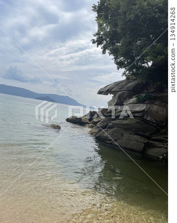 Quiet coastal scenery with rocks and clear sea background material Quiet coastal scenery with rocks and clear sea background material 134914268