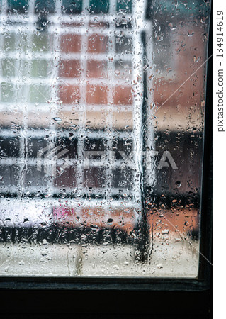 Rain Drops on Window with Blurred Urban Background 134914619