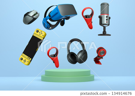 Assorted gaming gadgets like controllers, VR headset, mouse, and mic floating above circular podium and white platform 134914676