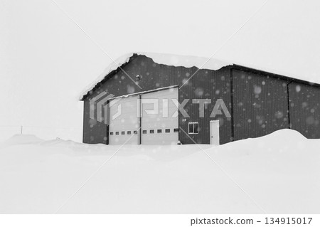 Industrial storage building covered with snow after snowfall. Industrial storage building covered with snow after snowfall. 134915017