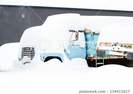 Old abandoned dump truck covered with high snow. Old abandoned dump truck covered with high snow. 134915027