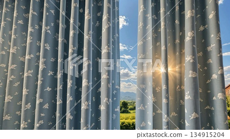 Behind the curtains is a bright sun and a peaceful landscape 134915204