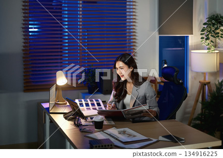 Women interior designer working in office at night 134916225