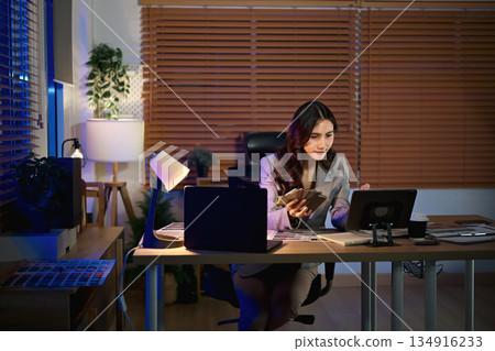 Women interior designer working in office at night 134916233