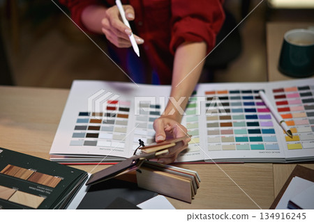 Architect designer Interior working hand selection material color samples art tools at night time Architect designer Interior working hand selection material color samples art tools at night time 134916245