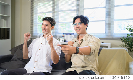 Photo Set Of Two Excited Male Friends Celebrate Watching Sports On Television At Home Photo Set Of Two Excited Male Friends Celebrate Watching Sports On Television At Home 134916340