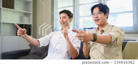 Photo Set Of Two Excited Male Friends Celebrate Watching Sports On Television At Home 134916362