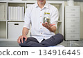 Closeup man holding jar of coin, Saving concept 134916445