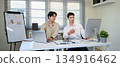 Two colleague analysis business data in computer at workplace 134916462