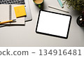 Digital tablet on office desk workspace with, pen, laptop, flower and hot coffee cup on white table 134916481