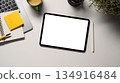 Digital tablet on office desk workspace with, pen, laptop, flower and hot coffee cup on white table 134916484