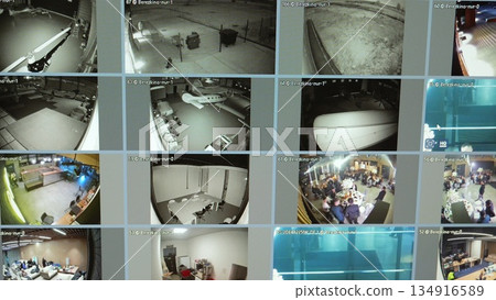 Security monitor displaying multiple surveillance camera feeds, monitoring parking lot, aircraft hangar, office spaces, and social gathering with comprehensive video tracking Security monitor displaying multiple surveillance camera feeds, monitoring parking lot, aircraft hangar, office spaces, and social gathering with comprehensive video tracking 134916589