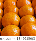 Fresh tangerines in boxes on the shelves of a grocery supermarket, tangerines on the shelves of a grocery store 134916903