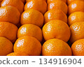 Fresh tangerines in boxes on the shelves of a grocery supermarket, tangerines on the shelves of a grocery store 134916904