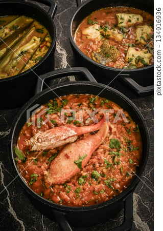 Portuguese traditional food fish soup and seafood risotto meal on restaurant table in lisbon Portuguese traditional food fish soup and seafood risotto meal on restaurant table in lisbon 134916936