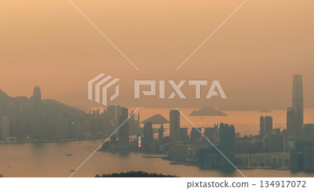 Hong Kong skyline glowing in warm golden light Dec 28 2021 Hong Kong skyline glowing in warm golden light Dec 28 2021 134917072