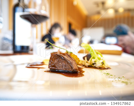 An elegant dinner party at a restaurant with lively conversation An elegant dinner party at a restaurant with lively conversation 134917862