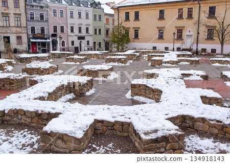 Winter scene in a historic town square with snow and stone foundations Winter scene in a historic town square with snow and stone foundations 134918143