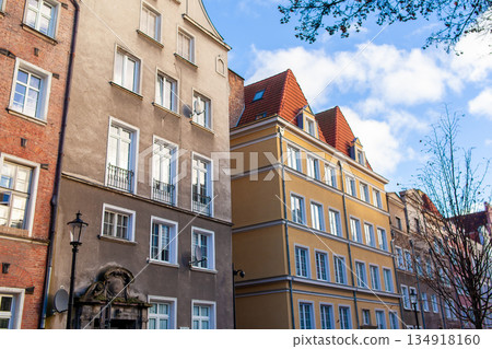 Buildings in a city under a blue sky with clouds on a sunny day 134918160
