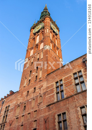 Clock tower stands tall against clear blue sky in historic town square 134918168
