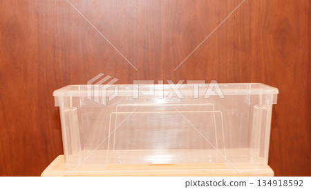 Rectangular transparent plastic container for food storage, ideal for packaging and preserving freshness. High quality photo 134918592