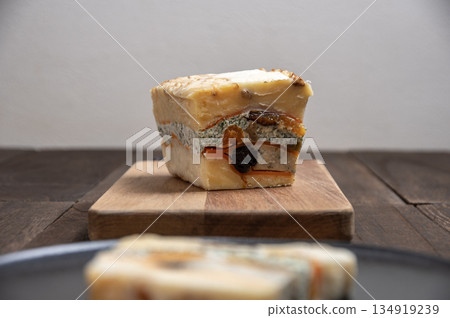 A rich cheese terrine made with luxurious dried fruits and nuts 134919239