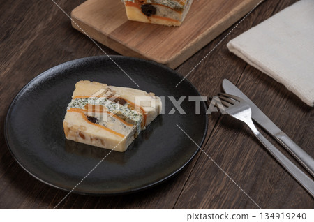 A rich cheese terrine made with luxurious dried fruits and nuts 134919240