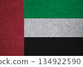 Flag of the UAE on an ancient concrete surface. Concept of Emirati heritage and patriotism.. 134922590