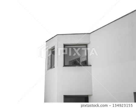 Minimalist white building corner with large glass windows and smooth facade, isolated on white 134923155