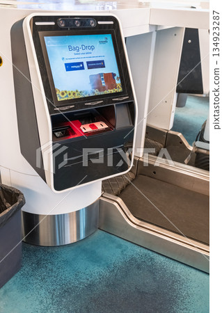Self-service bag drop kiosk at Changi Airport in Singapore featuring modern design and technology 134923287