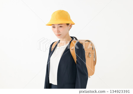 An adult woman carrying a school bag 134923391