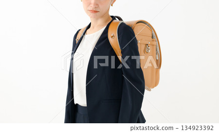 An adult woman carrying a school bag An adult woman carrying a school bag 134923392