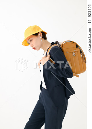 An adult woman carrying a school bag An adult woman carrying a school bag 134923393