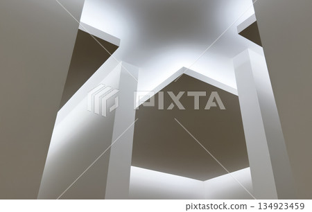Modern architectural ceiling design with suspended geometric panels and diffused lighting. 134923459