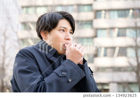 A cold-looking man in an office district 134923625