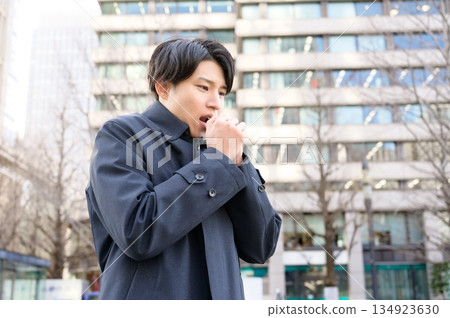 A cold-looking man in an office district A cold-looking man in an office district 134923630