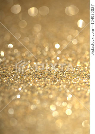 Gold shimmer glitter background with focus and bokeh Gold shimmer glitter background with focus and bokeh 134923827
