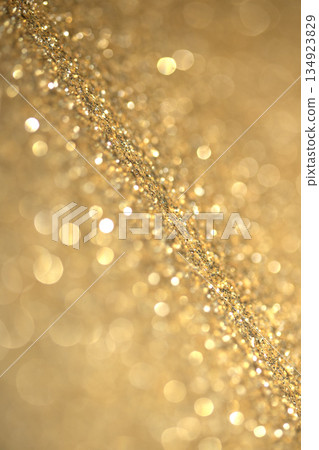 Gold shimmer glitter background with focus and bokeh 134923829