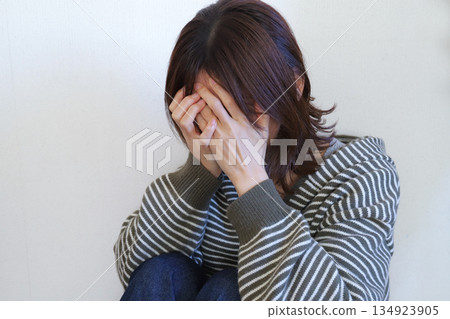Sad woman covering her face 134923905