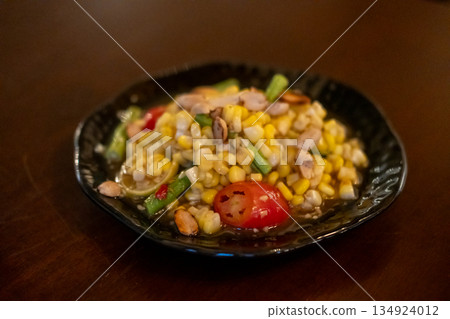 Spicy corn with salted egg salad, or Som Tum with corn, served on plate. Spicy corn with salted egg salad, or Som Tum with corn, served on plate. 134924012