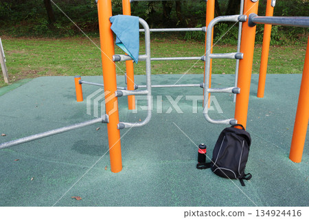 Calisthenics equipment in outdoor park with backpack and water bottle Calisthenics equipment in outdoor park with backpack and water bottle 134924416