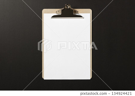 Blank white paper on wooden clipboard on dark background. template mock up Blank white paper on wooden clipboard on dark background. template mock up 134924421